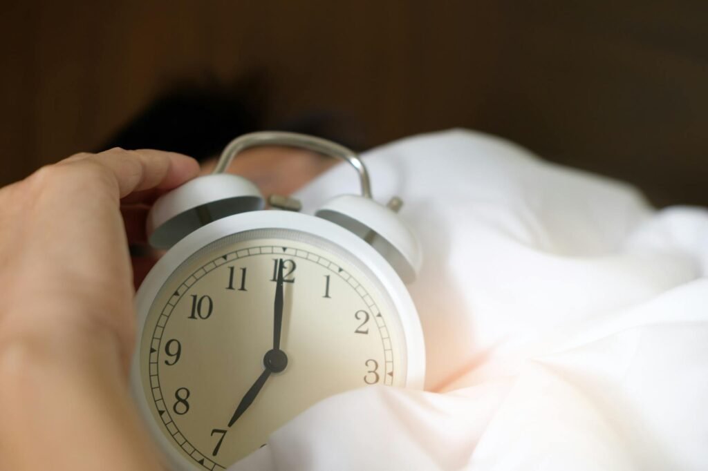 Morning sunlight entering a bedroom with an analog clock visible.