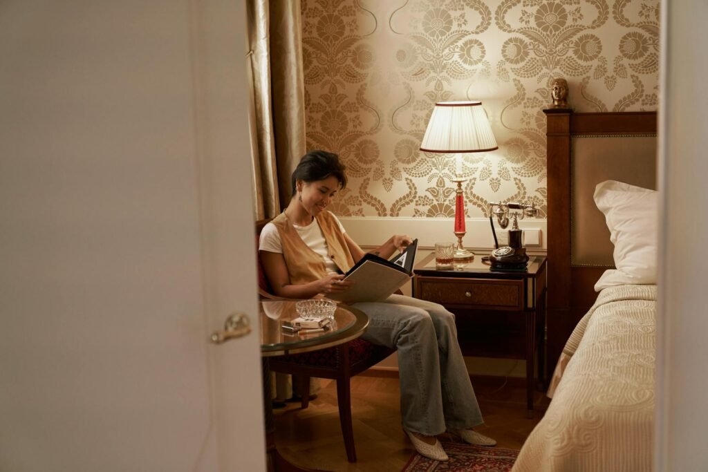 A quiet bedside setup with a book and soft lamp light, with the phone placed away from the bed.