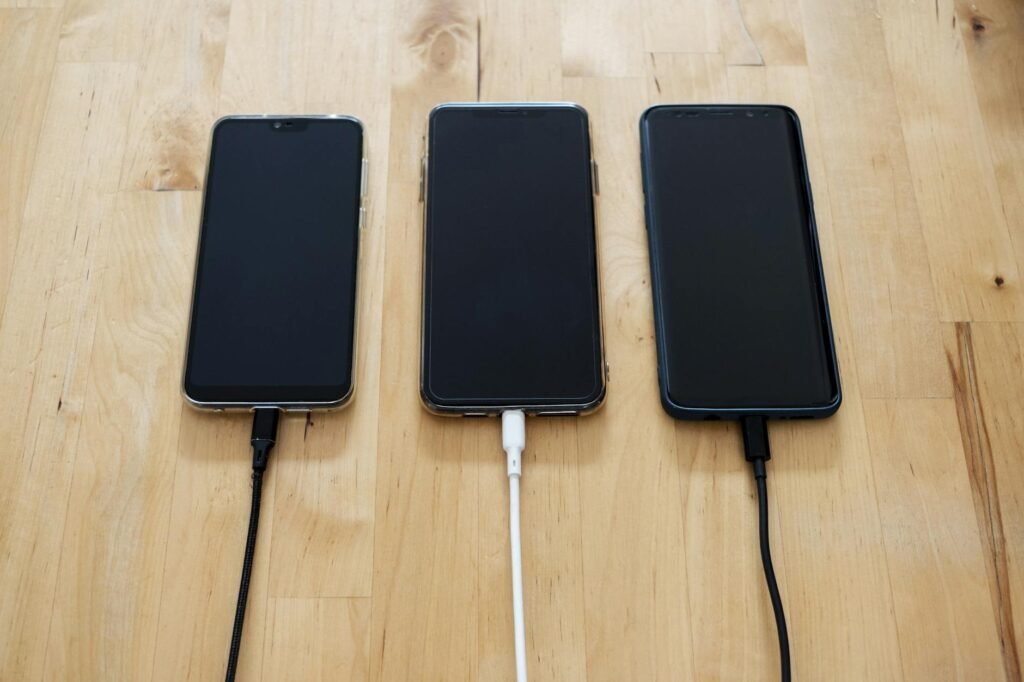 A smartphone charging away from the bed on a kitchen counter at night.