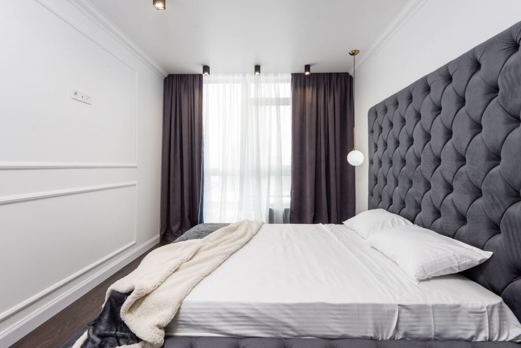 A calm bedroom with blackout curtains drawn and minimal light leakage