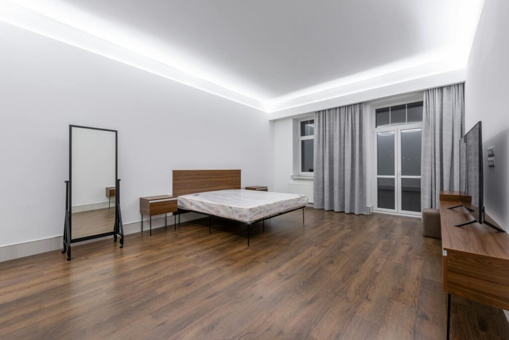 A tidy bedroom with soft lighting and blackout curtains