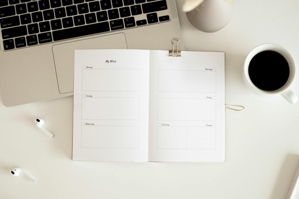 A handwritten sleep log and weekly planner on a kitchen table.