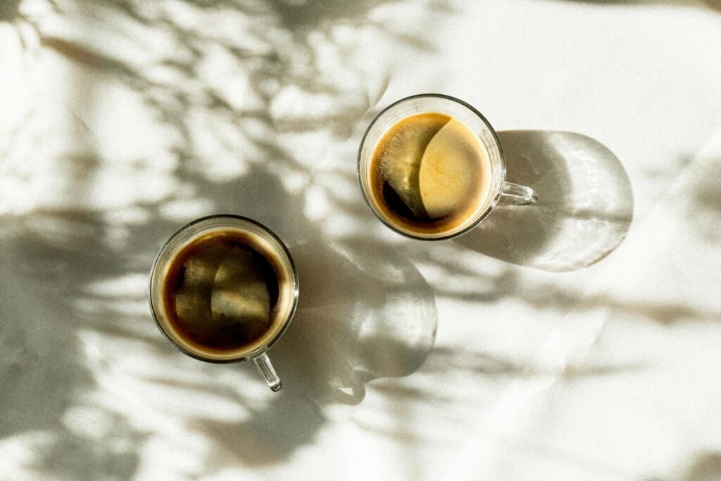 A kitchen table with coffee and a planner in bright morning light